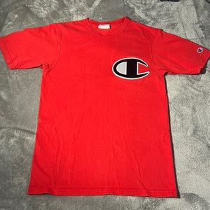 This is a champion shirt. True to its size, it’s a small. The color is red.